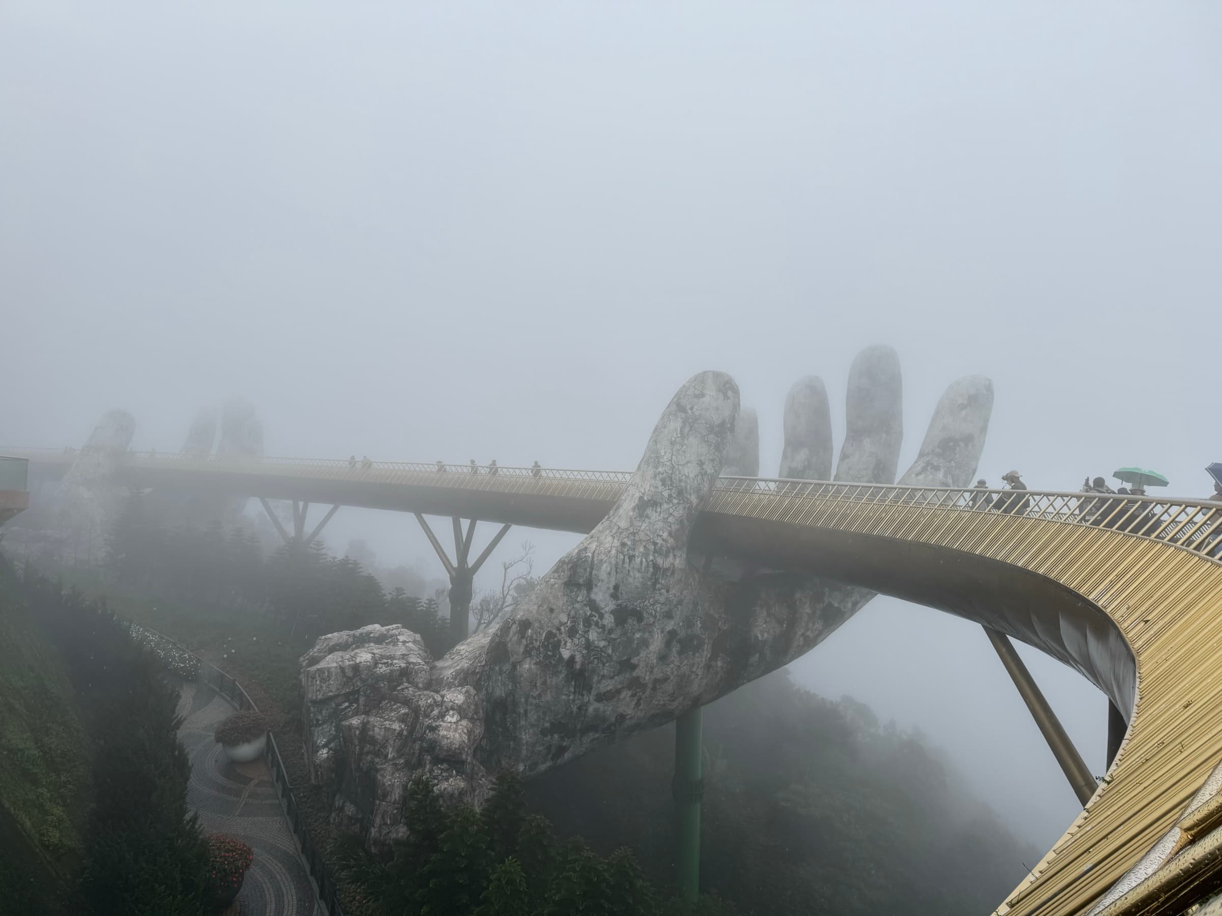 The Golden Bridge held aloft by giant stone hands at Ba Na Hills, Da Nang